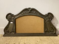 An Art Nouveau period patinated cast metal over mantel mirror frame, the scrolling frame typically