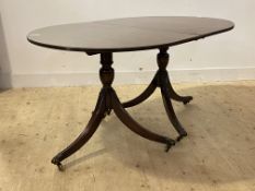 A Regency style inlaid mahogany twin pillar dining table, the oval top over turned column and triple