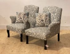 A pair of contemporary upholstered armchairs, with squab cushion, raised on shaped supports,
