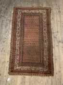 An Antique Khamesh rug, hand knotted, the field with boteh motif enclosed within a multi line border