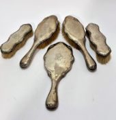 A five piece Edwardian Chester 1913 silver backed dressing table brush set comprising mirror with