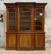 A Good Victorian mahogany breakfront bookcase, the the projecting cavetto moulded corner over
