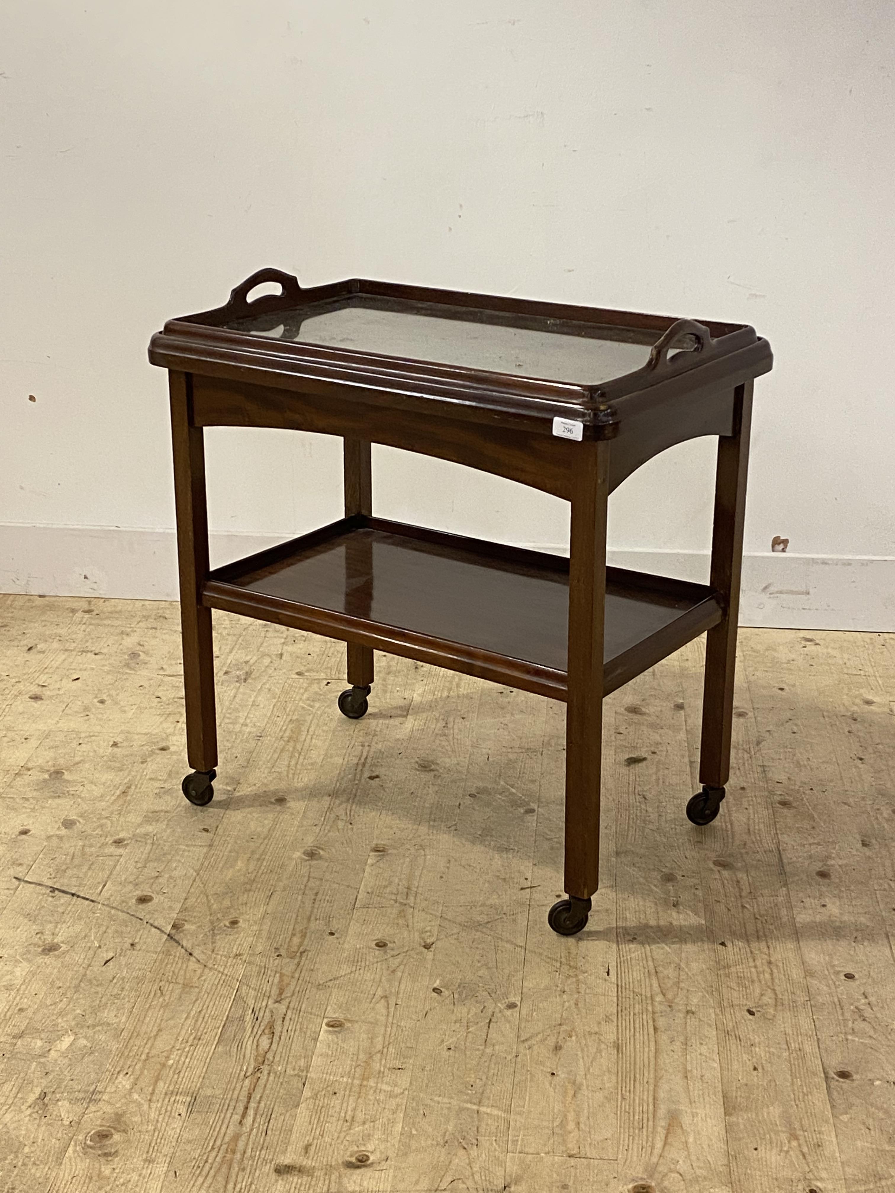 An early to mid 20th century mahogany drinks trolley, the top with lift off tray top over an under