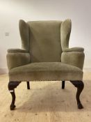 An 18th century style Wingback armchair, early 20th century, the back, outswept arms and seat