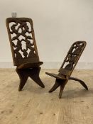 An African hardwood tribal birthing style chair, with carved figural openwork back, (H85cm) together