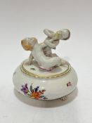 A Herend Hungarian porcelain circular dish mounted with two cherubs playing with stylised floral and