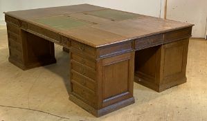 A monumental 19th century oak quadruple pedestal partners desk, the top inset with tooled green