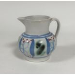 A Buchan Scottish pottery jug decorated with stylised flower and leaf design, (18cm x 11cm)