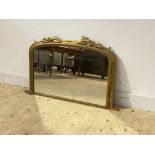 A Victorian overpainted gilt framed over mantel mirror, the arched top with carved acanthus leaf