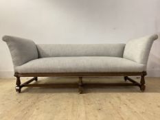 A Victorian mahogany boudoir settee, well upholstered in a natural linen, with low back and scrolled