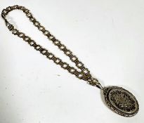 A Victorian oval white metal locket with engraved decoration and gadroon border mounted on white