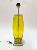 A lemon coloured glass ovoid table lamp with chrome mounted top and stepped square base, (