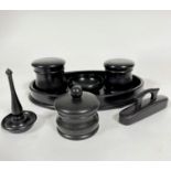 An Edwardian ebony seven piece dressing table set including two circular dishes with domed