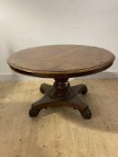 A mid 19th century plum pudding mahogany dining or centre table, the circular top on a turned column
