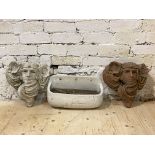 A near pair of wall pocket planters formed as masks, together with a glazed terracotta wall pocket