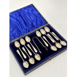 A set of twelve Sheffield silver old English pattern teaspoons complete with tongs with engraved