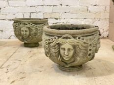 A pair of reconstituted stone garden planters of cylindrical form with Grecian imagery, D37cm
