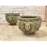 A pair of reconstituted stone garden planters of cylindrical form with Grecian imagery, D37cm
