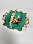 A 19thc English china basket of scalloped design with pierced gilt handles to side, with centre