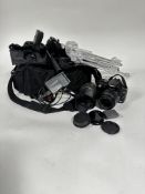 A black nylon camera bag containing a Canon E0S digital camera 350D, complete with extra battery,