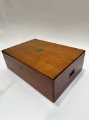 An Edwardian oak table canteen box, with shield set brass inset plaque to top and recessed brass