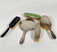 A Birmingham silver engine turned decorated three piece dressing table brush set with engraved