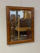 A late 20th century ebonised and burr elm framed wall mirror with bevelled plate 60cm x 74cm