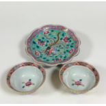A pair of Chinese famille rose yellow ground bowls, each with scalloped rim and painted to the