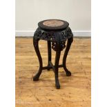 A late 19th century Chinese ebonised hardwood jardiniere stand, the circular top inset with