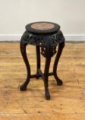 A late 19th century Chinese ebonised hardwood jardiniere stand, the circular top inset with