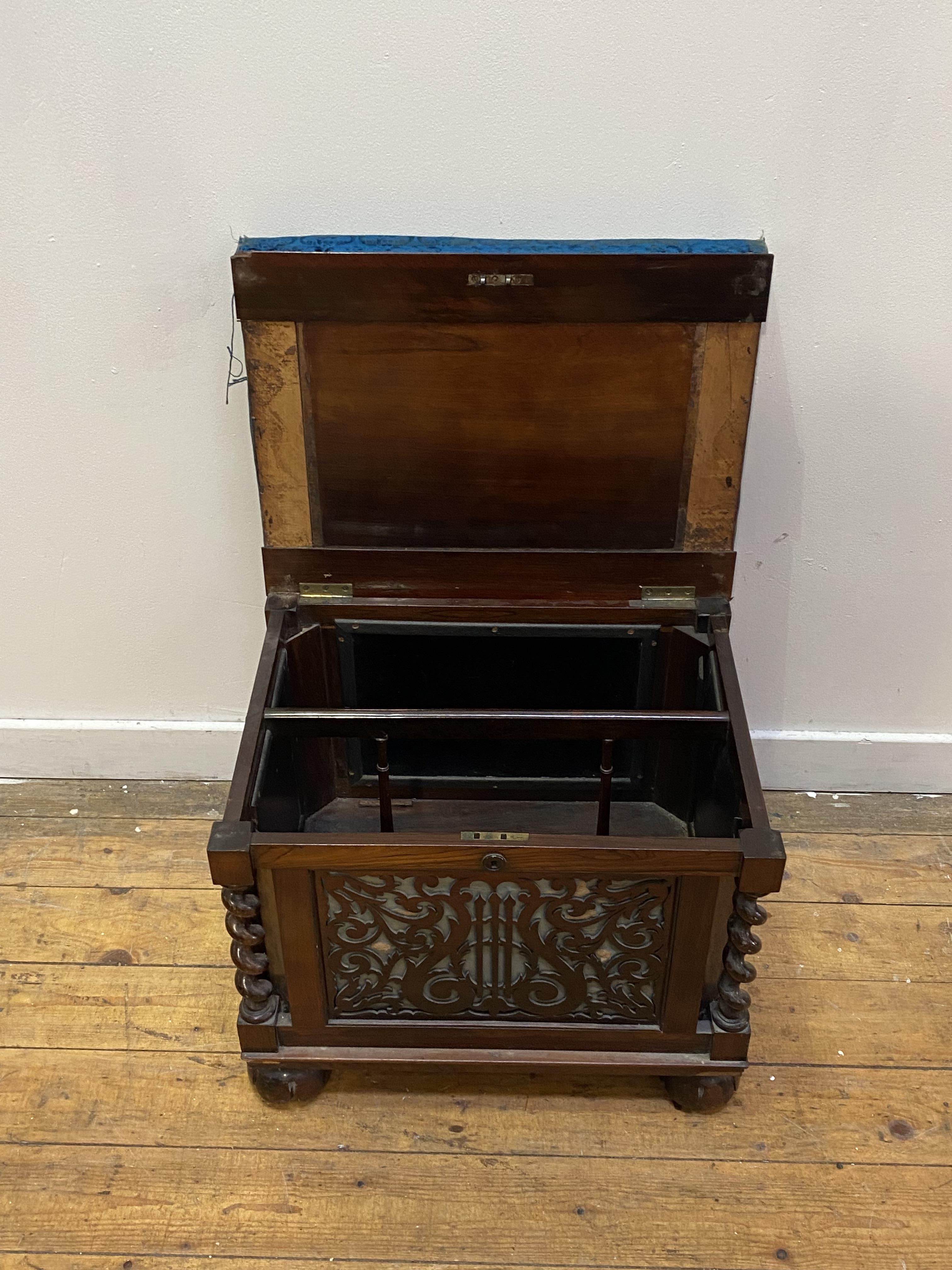 An early Victorian rosewood music stool, the worn blue velvet upholstered top lifting to an interior - Image 3 of 4