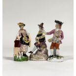 A Meissen style figure of a Harlequin, his costume decorated with playing cards, playing a