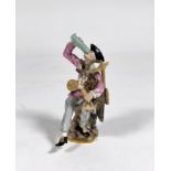 A Meissen style figure of a Harlequin drinking from a passglass and holding a goatskin bagpipe,