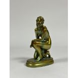 Zsolnay Pecs: a figure of a kneeling female nude, in an eosin green/gold glaze, printed mark. Height