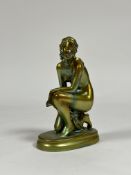 Zsolnay Pecs: a figure of a kneeling female nude, in an eosin green/gold glaze, printed mark. Height