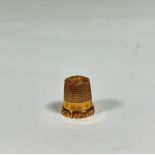 A 9ct gold thimble, engraved with initials, in it's original leather case. 2.9 grams