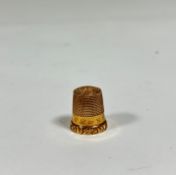 A 9ct gold thimble, engraved with initials, in it's original leather case. 2.9 grams