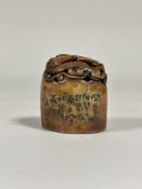 A Chinese soapstone seal, oval, carved in relief with a dragon, and bearing an inscription to one