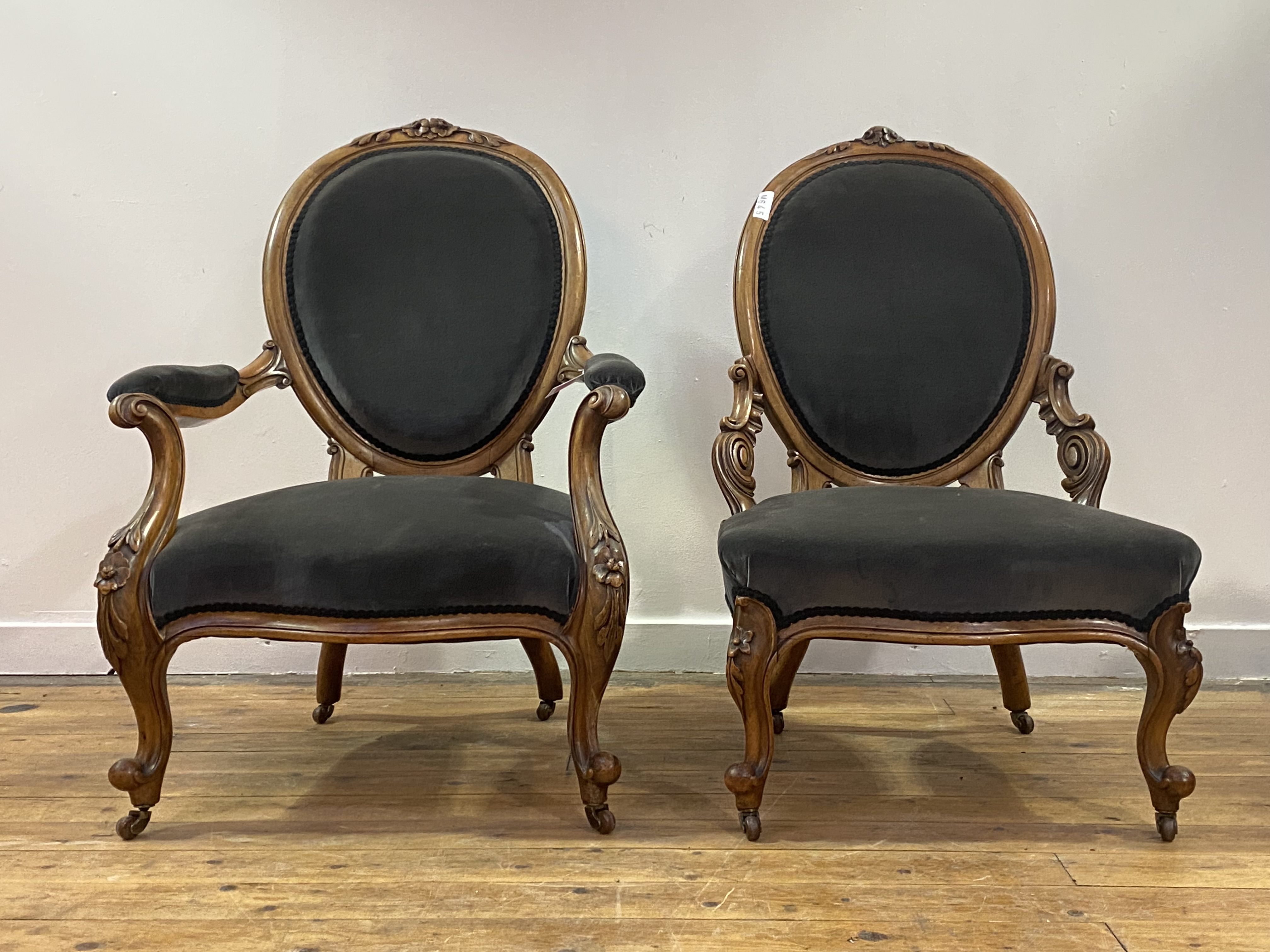 A pair of mid Victorian His and Hers walnut framed easy chairs, the oval back with floral carved - Image 2 of 3