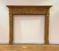 A George III pine and gesso fire surround, late 18th century, decorated with swags, lion masks,