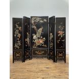 A Chinese lacquered four fold concertina screen, circa 1920-30, each panel with hardstone inlay