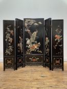 A Chinese lacquered four fold concertina screen, circa 1920-30, each panel with hardstone inlay