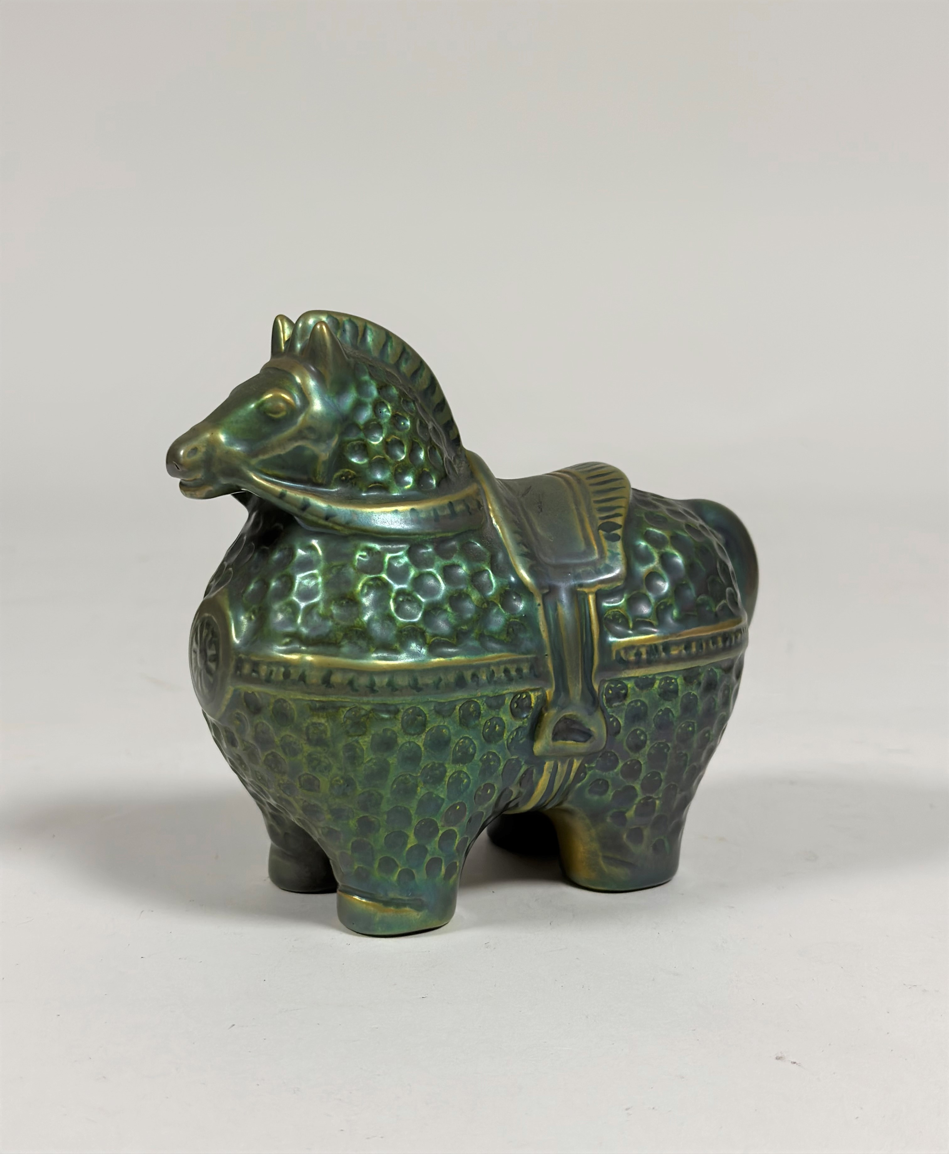 Zsolnay Pecs: a modernist model of a horse, designed by Judit Nador, in an eosin green/gold glaze,