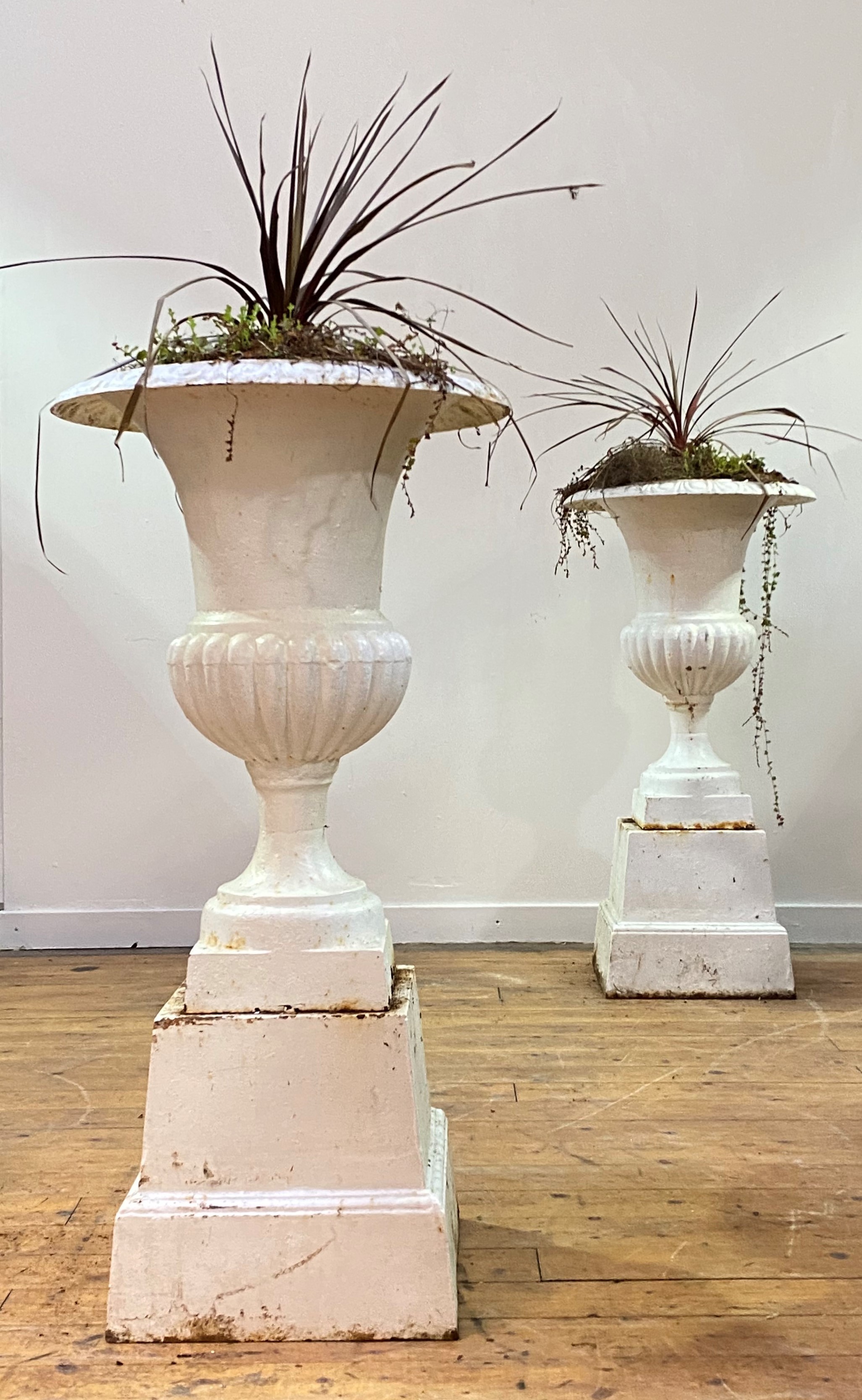 A pair of white-painted cast-iron garden urns on stands, the urns of campana form, on square section - Image 4 of 4