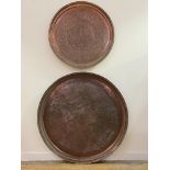 A very large Islamic copper tray or table top, profusely engraved with bands of palmettes and