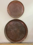 A very large Islamic copper tray or table top, profusely engraved with bands of palmettes and