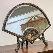 A black Japanned Chinoiserie easel mirror of fan form, the frame gilt-decorated, with bevelled