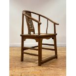 A Chinese elm horseshoe back chair, late 19th/ early 20th century, the sweeping crest rail with