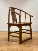 A Chinese elm horseshoe back chair, late 19th/ early 20th century, the sweeping crest rail with