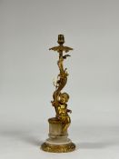 A Rococo Revival gilt-metal and alabaster table lamp, modelled with a putto holding a trident and